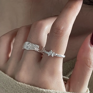 Silver starburst rings set with hammer texture and zircon accents on model hand