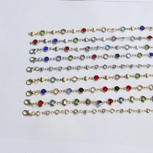 Set of nine bohemian gold bracelets with colorful round and heart-shaped gemstones
