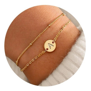 Double-layered gold stainless steel bracelet with beaded chain and initial A pendant