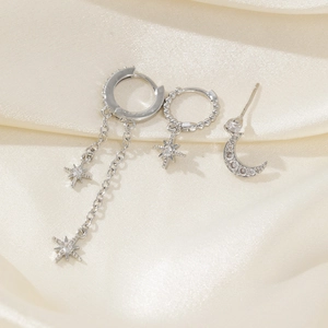 Macro detail of silver moon and star earrings set with sparkling cubic zirconia