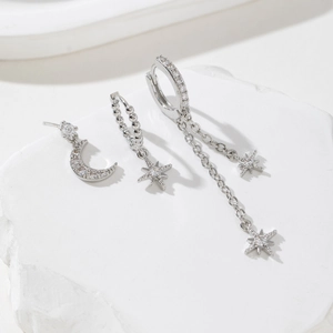 Star and moon asymmetric earrings set with white zircon in silver-tone metal finish