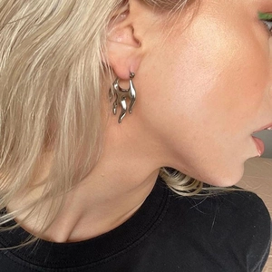 Chic silver flame hoop earrings with Y2K metallic design for a bold fashion statement
