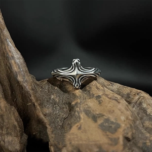 Gothic vintage silver alloy cross ring with distressed finish on rustic wood