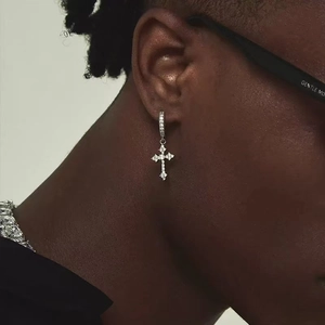Close-up of silver cross hoop earring with micro-paved cubic zirconia worn by model