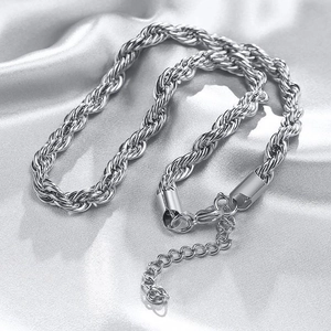 Macro detail of silver rope chain link texture with lobster clasp and extension chain