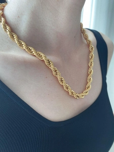 Close-up of chunky 8mm 18K gold-plated twist rope chain necklace on female model