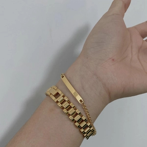 Gold-tone titanium steel chain bracelet set with rectangular tag shown on a wrist