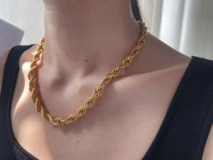 Detail of 8mm thick 18K gold plated twist rope chain necklace worn by a model
