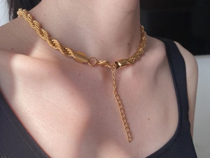 Macro detail of 18K gold plated twisted rope chain necklace with adjustable metal extender