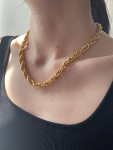 Close-up of 8mm golden rope chain necklace on model showing classic woven texture