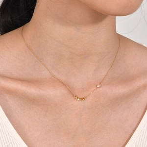 Macro view of 18K gold stainless steel chain necklace with sparkling zircon on model