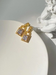 Detail of gold-plated padlock earrings with a square zircon and micro-pave crystals