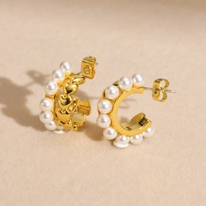 Elegant gold-plated C-shaped earrings with white pearls and inner heart-shaped design