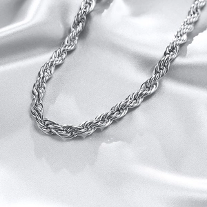 Polished silver rope chain necklace with elegant 8mm twisted design on silk background