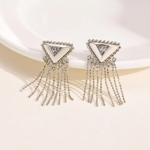Detail of silver tassel earrings with triangular cubic zirconia and beaded chain fringe