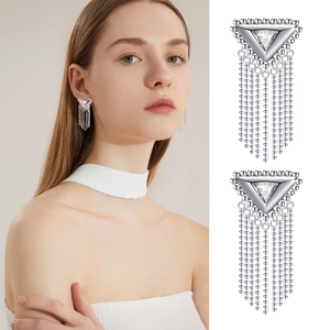 Macro view of silver tassel drop earrings with triangular cubic zirconia and bead chains