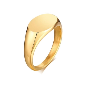 Macro shot of minimalist gold signet ring featuring a polished oval top and glossy metal finish