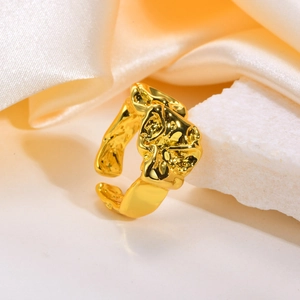 Detailed close-up of golden adjustable ring with irregular lava texture on white mineral stone