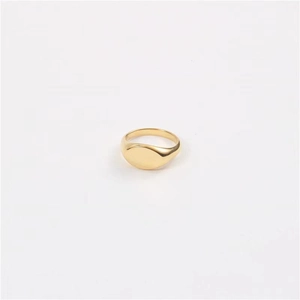 Macro detail of polished gold-plated ring showing smooth surface and metallic texture