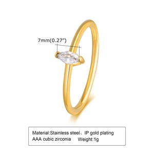 Macro view of gold stainless steel ring with marquise cut emerald green zirconia