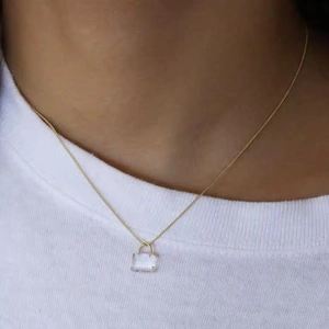 Gold adjustable necklace featuring a minimalist square transparent padlock pendant