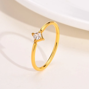 Minimalist gold titanium steel ring with single square cubic zirconia in four-prong setting