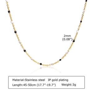 Detail of 2mm black and white beads on a gold-plated stainless steel chain necklace