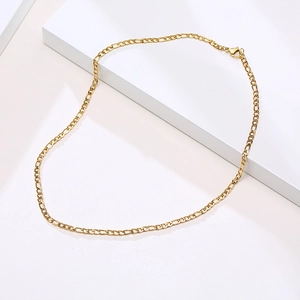 Detail view of 3mm gold stainless steel Figaro chain necklace with secure lobster clasp