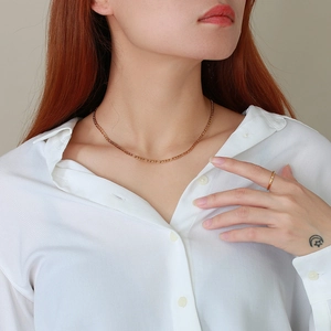 Minimalist 3mm gold Figaro chain necklace in stainless steel shown on female model