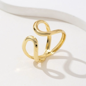 Detail shot of wavy gold line ring with polished finish and modern open design