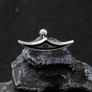 Punk spider web earrings in stainless steel on black volcanic rock for Halloween