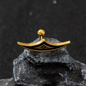 Gothic gold spider web crescent stud earring on black rock background