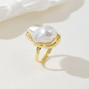 Macro view of baroque irregular pearl ring with hammered gold texture in an elegant style