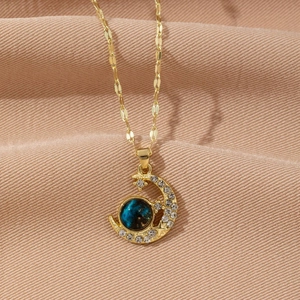 Elegant gold necklace with micro-pave crescent moon and blue starry sky astronaut pendant