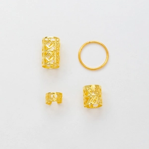 Detail of 4-piece gold hair jewelry set featuring hollow geometric dreadlock cuffs and rings