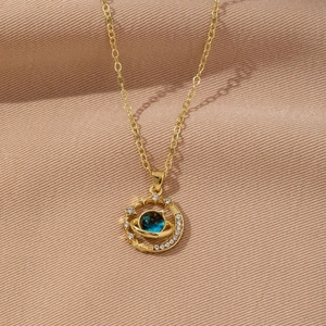 Macro shot of gold planet necklace featuring blue nebula stone and sparkling crystals
