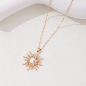 Golden bohemian sun and crescent moon pendant necklace with delicate crystal accents