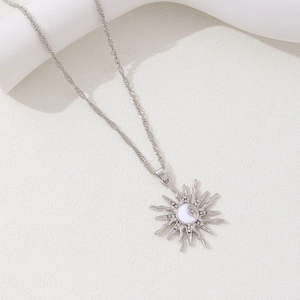 Silver sun and moon pendant necklace with crystal accents on a fine rope chain