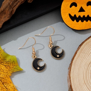 Détail de boucles d'oreilles lune noire avec étoiles dorées pour Halloween