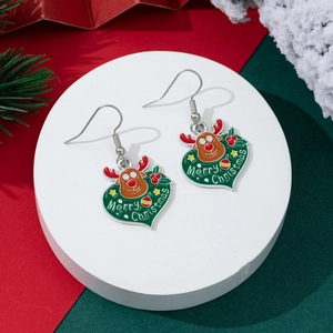 Detail of Christmas heart earrings with reindeer design and Merry Christmas lettering