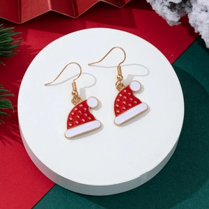 Weihnachtsmützen-Ohrringe mit Emaille und Goldstern auf festlichem Displayständer