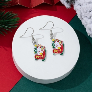 Detail of festive Christmas earrings featuring Santa on a sleigh with a tiny holiday tree