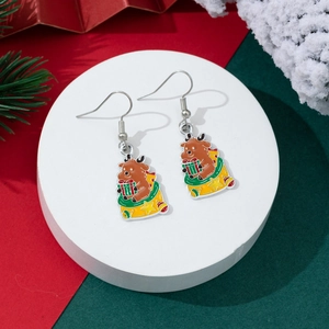 Detail of Christmas reindeer earrings featuring a cute deer in a gift bag with festive charms