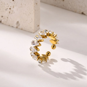 Detailed close-up of golden stainless steel ring with marquise-shaped white zircons