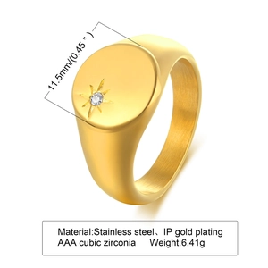 Macro detail of gold stainless steel signet ring with starburst engraving and cubic zirconia