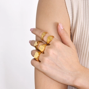 Close-up of elegant stackable gold rings featuring heart and starburst zircon details
