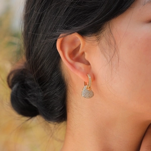 Elegant gold-plated copper heart drop earrings with shimmering zircon stones worn by a model