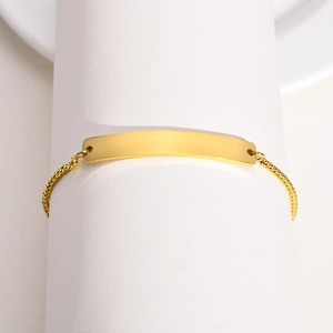 Minimalist adjustable gold stainless steel bar bracelet with round bead chain on a white display