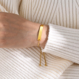 Minimalist gold stainless steel bar bracelet with adjustable box chain on wrist