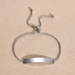 Close-up of polished silver stainless steel bolo bracelet with adjustable box chain